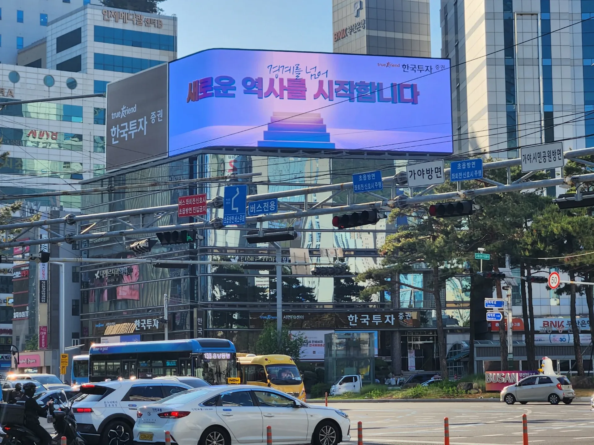 도심 건물 옥상에 설치된 대형 LED 전광판이 영상 콘텐츠를 송출하는 모습